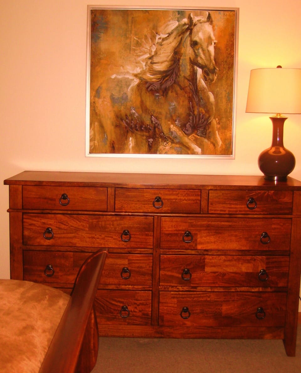 Beautiful craftsman furniture and king sleigh bed in master suite 