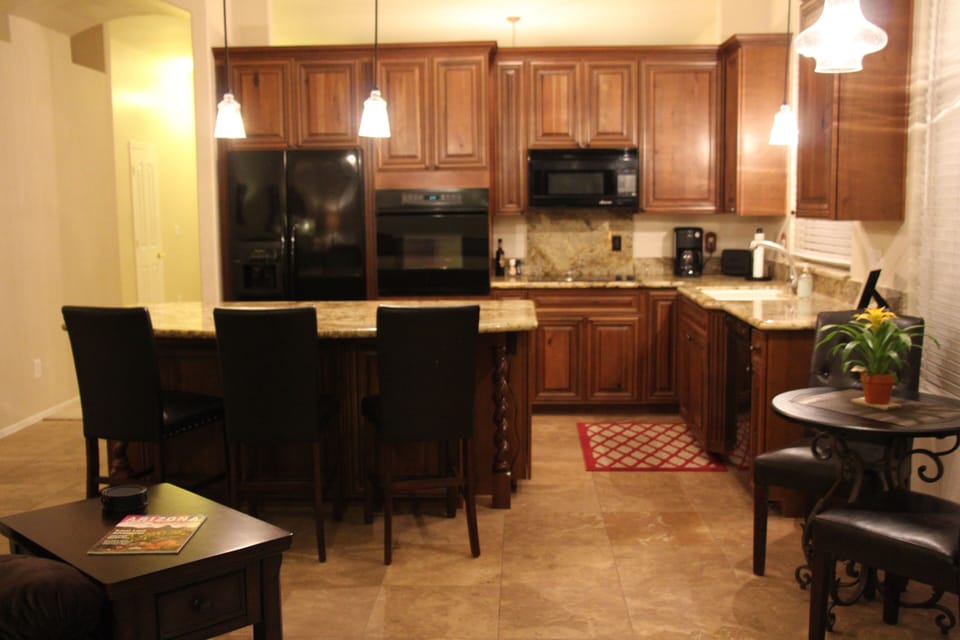 Kitchen with large island.  Plenty of bakeware and kitchen tools.