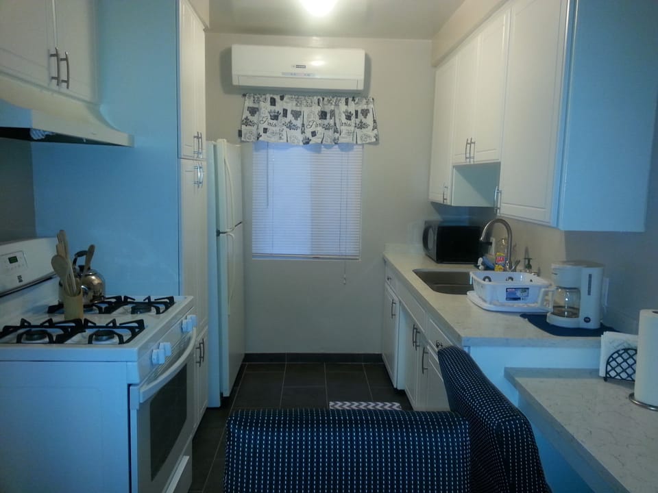 Complete kitchen with coffee maker, toaster, blander, refrigerator, teapot, etc.