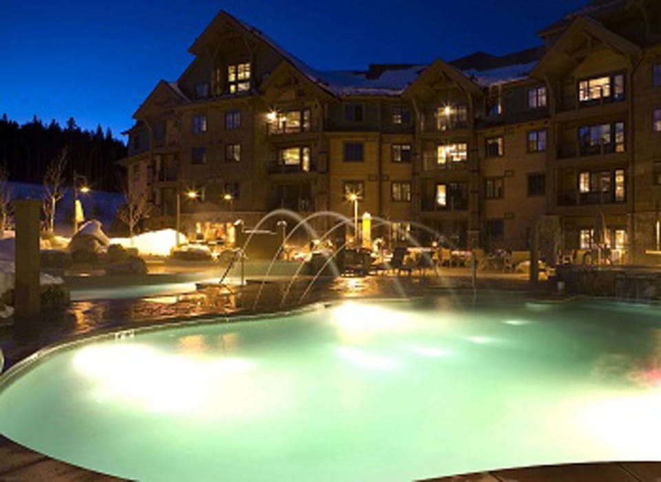 Outdoor pool and hot tub area at night