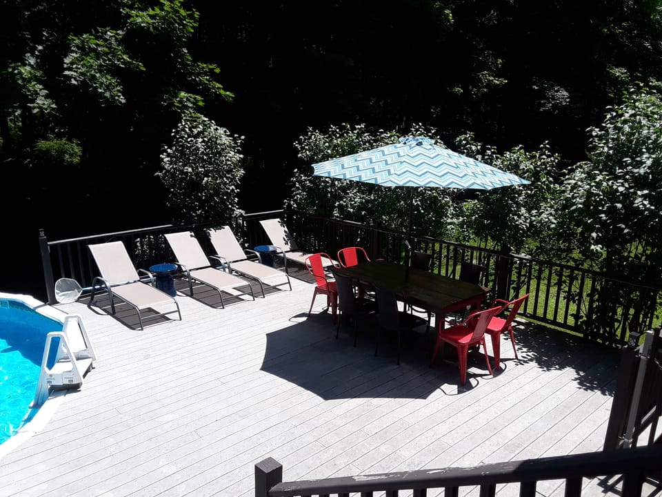 Deck. 4 lounge chairs.  Six-feet dining table seats 6-8.  