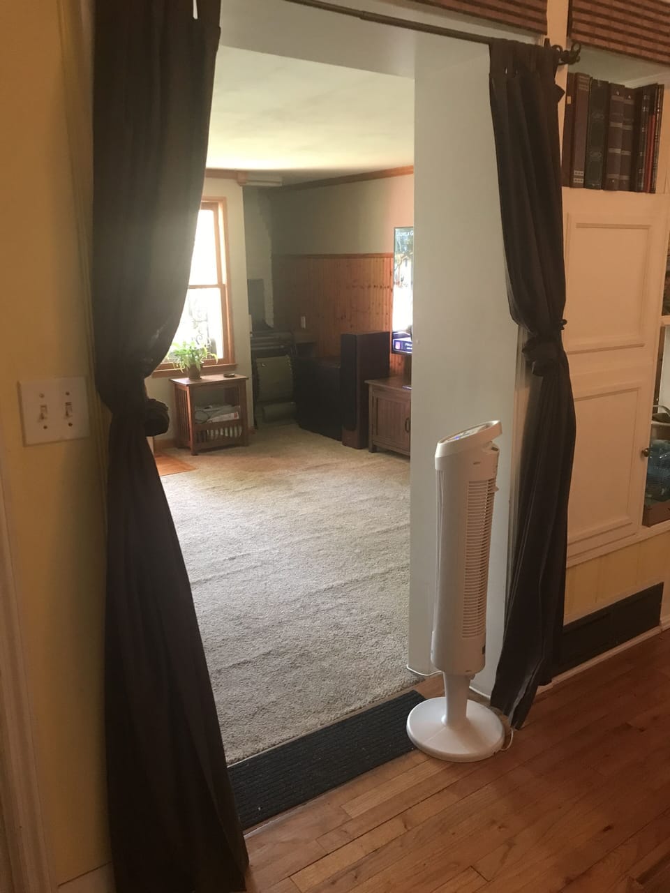Den includes a couch, large TV, and convertible chair bed. 