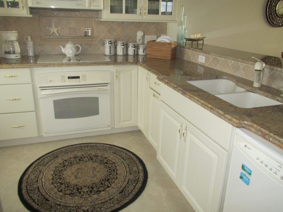 The recently updated kitchen includes modern appliances & granite counter tops.
