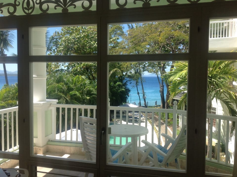 Inside condo looking out to balcony
rocking chairs and table.