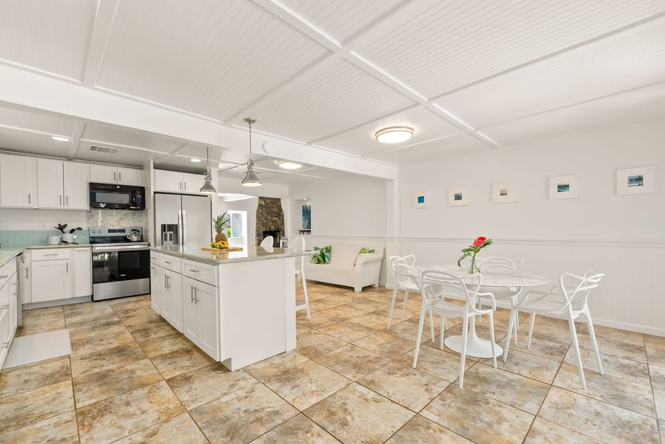 Your open-concept kitchen and dining space features modern stainless-steel appliances, bright white cabinetry, and a welcoming island perfect for meal prep and casual gatherings.
