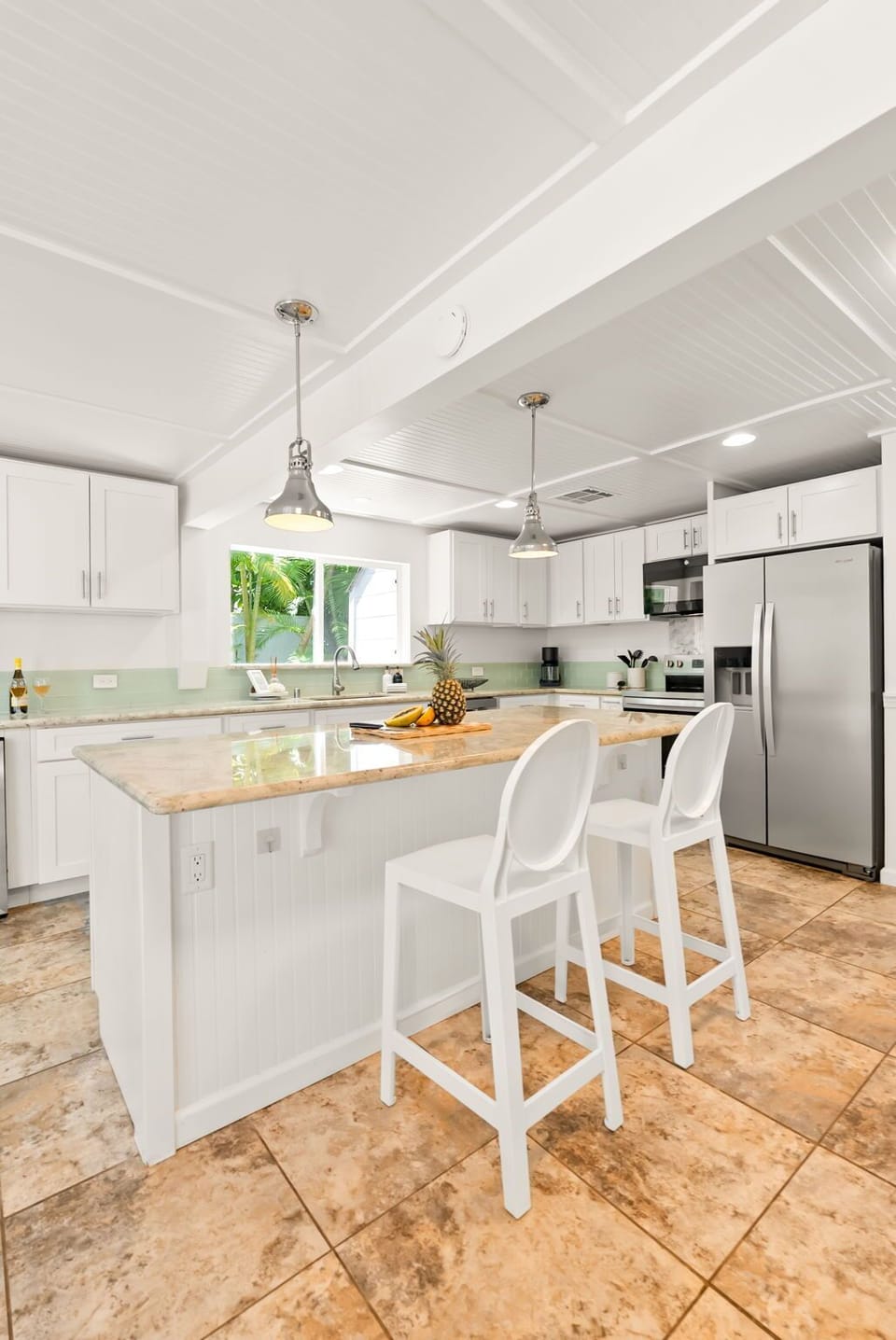 Gather around the spacious kitchen island with gleaming granite countertops, modern stainless appliances, and bright natural light streaming through the window. Your perfect spot for morning coffee and meal prep.