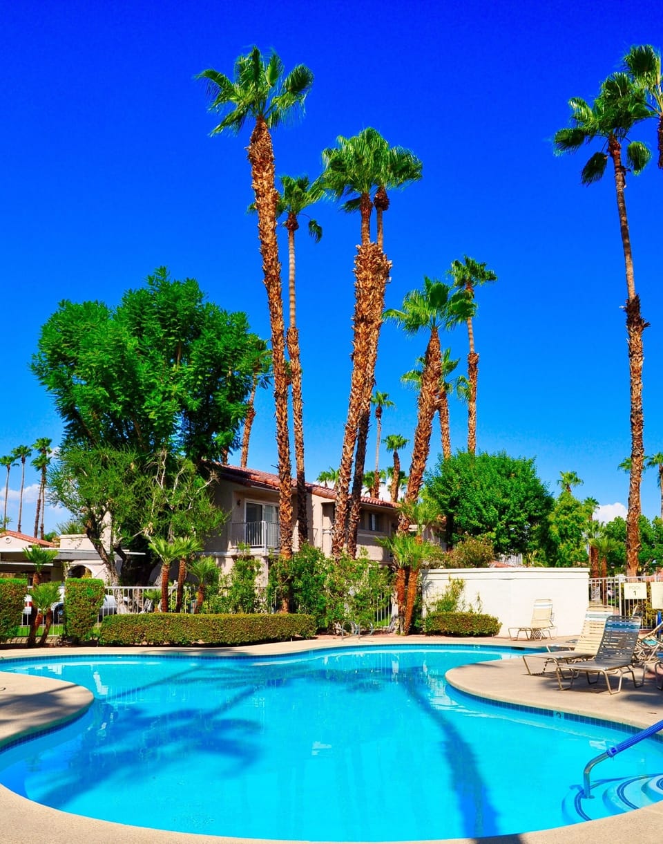 Two pools and a tennis court are steps away from the front door of your Palm Springs modern oasis rental.