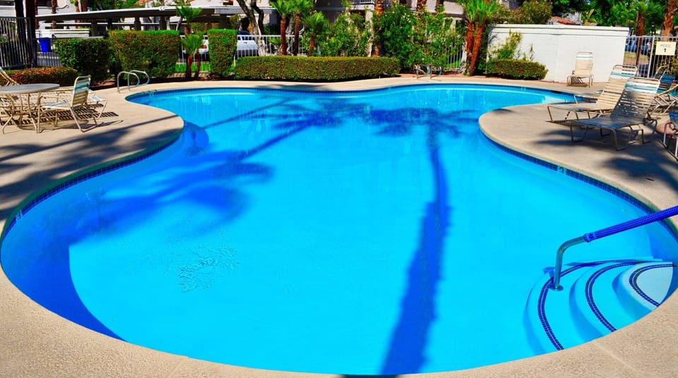 Enjoy refreshing pools under swaying palm trees under Palm Springs blue skies.