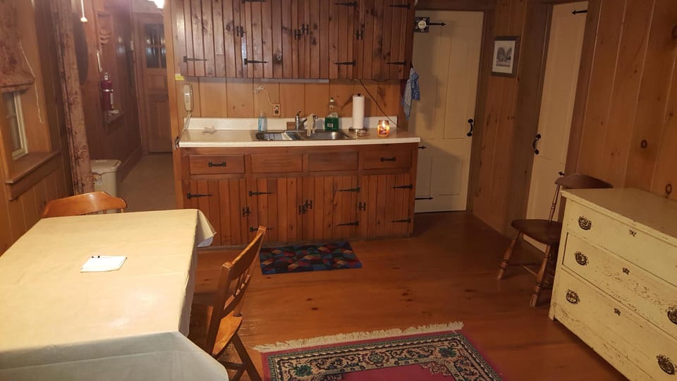 Dining area, looking into galley kitchen. Bath & Bedroom #1 doors on the right. 