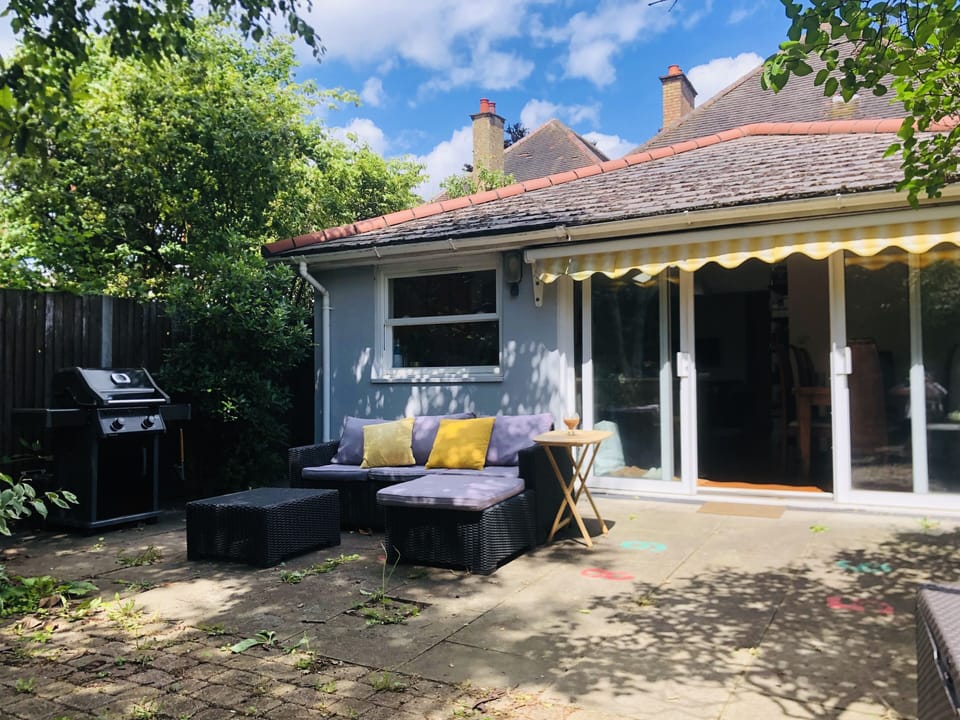 Back garden with outdoor sofa and bbq