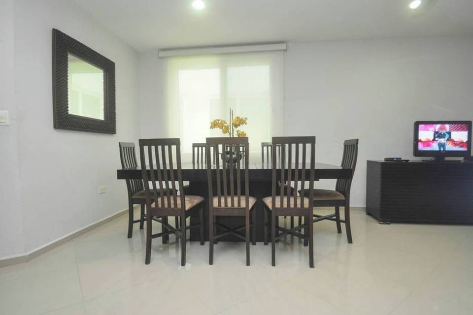 Share stories over dinner at the large table that seats 8 guests.
