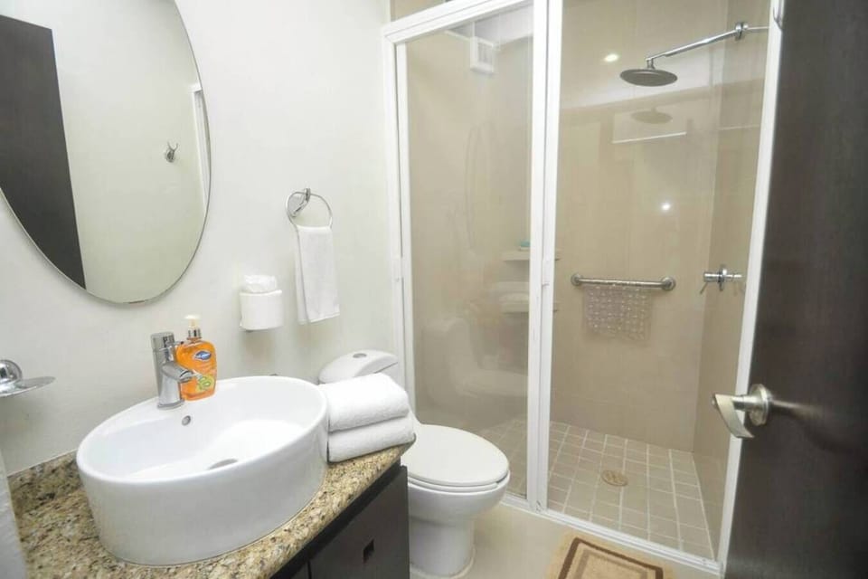 Refresh in the sleek, modern bathroom after a sunny beach day.
