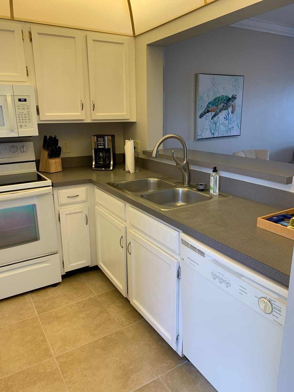 Well equipped kitchen with coffee maker, blender, ice maker and toaster.