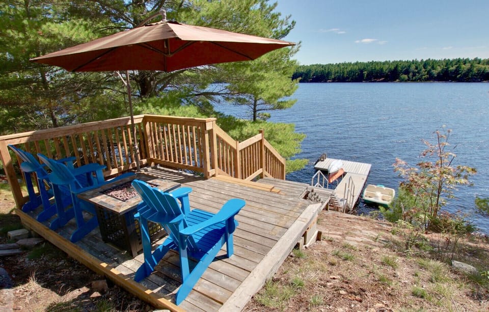 Lakeside deck with Fire table and dock.