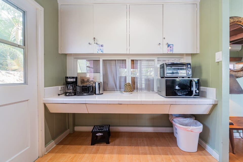 Kitchen area includes coffee maker microwave and toaster oven