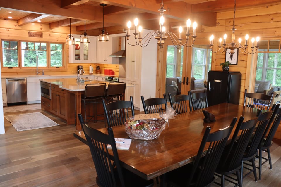 Custom solid Walnut Dining room table (seats 12+) and view of the kitchen..