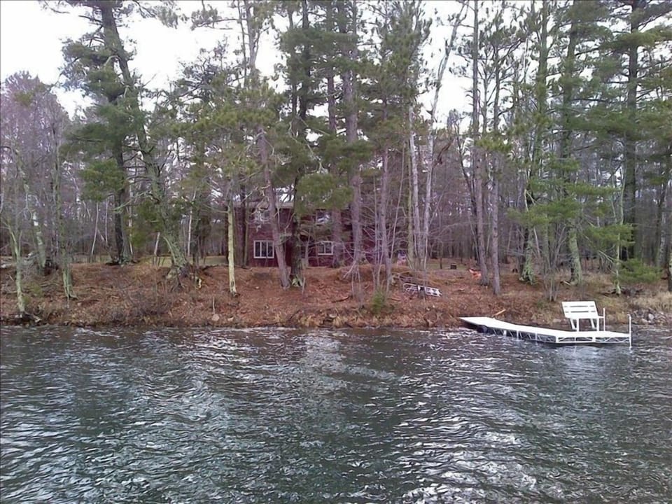 View from lake in early spring.  Dock, huge fire pit, grill, screened porch.