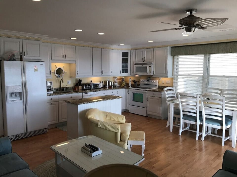 Kitchen is well equipped in appliances and cooking utensils, table seats six.