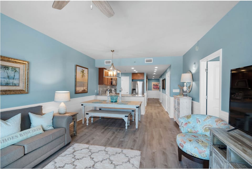Unwind in your spacious open-plan haven where coastal blues meet modern comfort, complete with fully equipped kitchen and cozy seating.