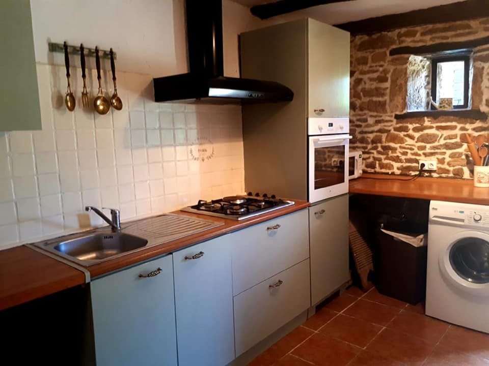 Kitchen with full size fridge, oven, microwave, washing machine.