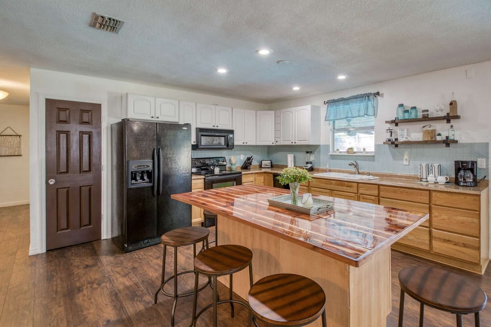 The kitchen comes fully stocked with dishes and cooking items along with a great island to gather around for conversation.