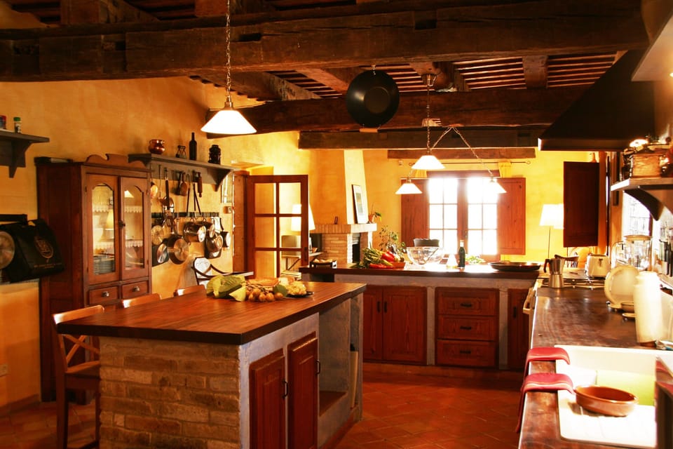 Large country-style kitchen with island ideal for various people cooking. 