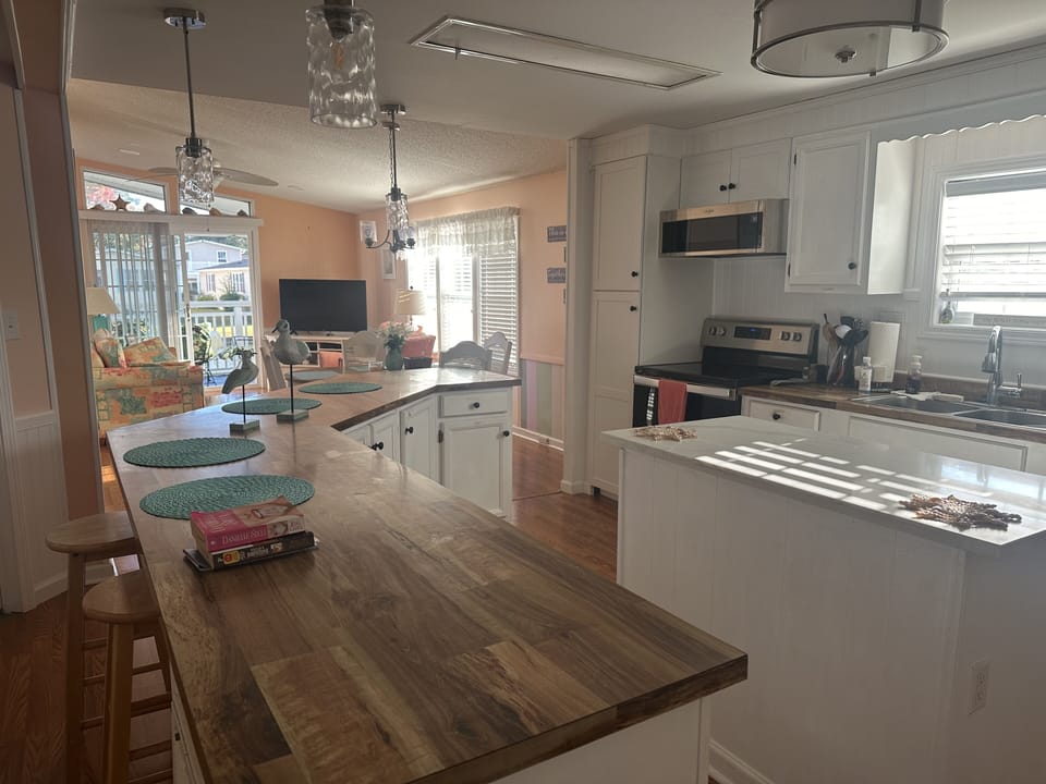 Fully-stocked kitchen through to living room.