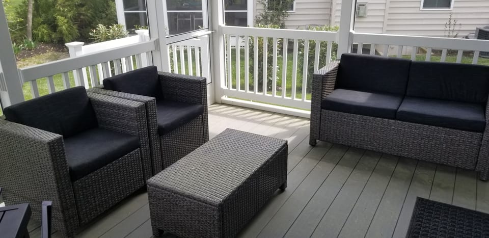 Comfortable seating on the screened porch -- bring out your book or your drink