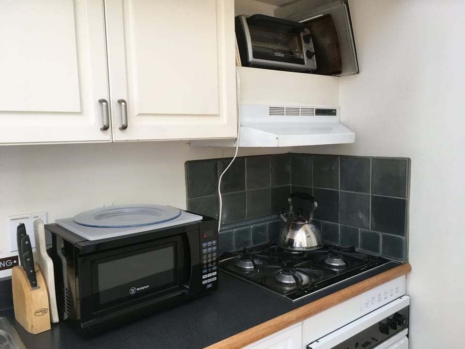 Kitchen has coffee maker, microwave, toaster oven, gas range & convection oven