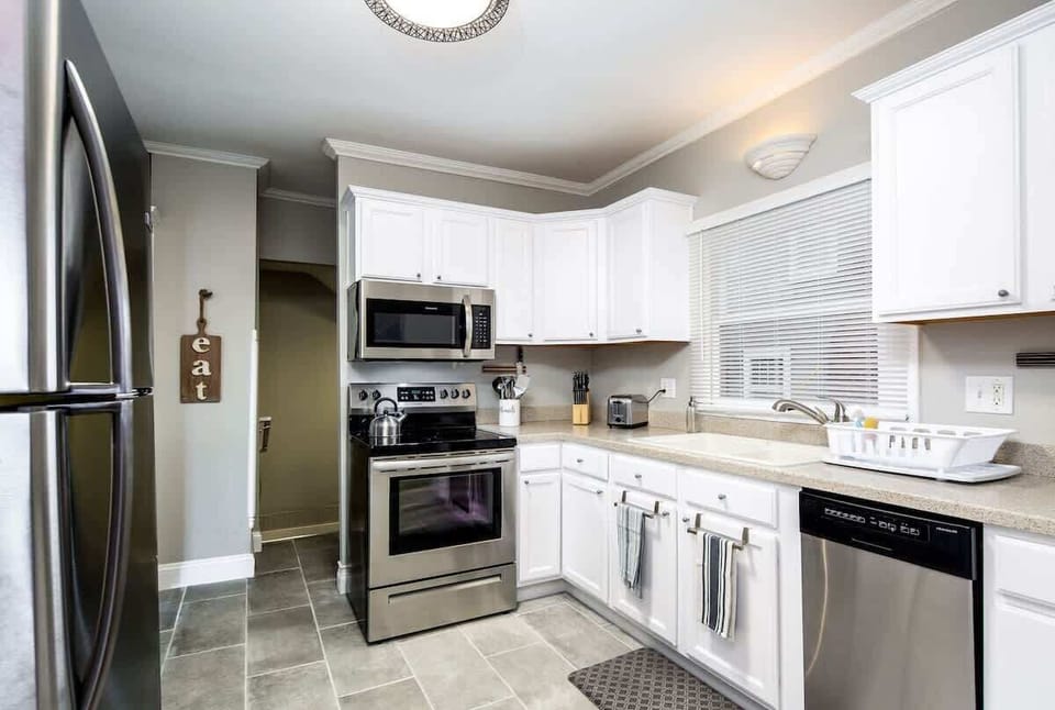 Newly updated kitchen with stainless appliances. The half bath is right off the kitchen and basement stairs are right off the kitchen. 