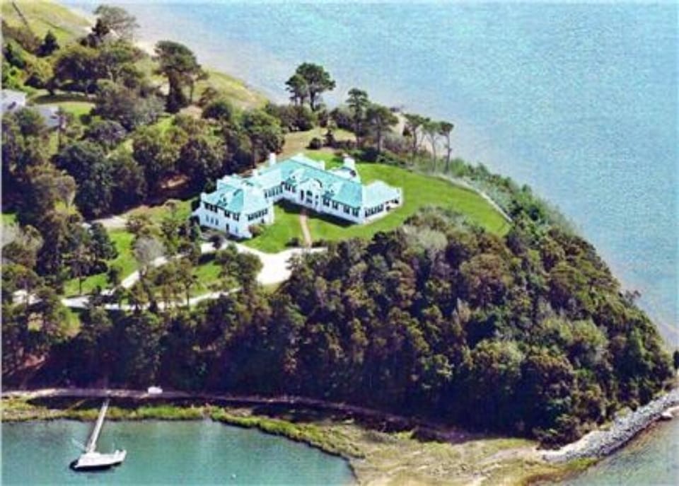 Aerial of the property. A point of land into Pleasant Bay. Water all around.