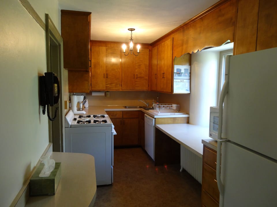 Kitchen stocked with pots, pans, dishes, utensils