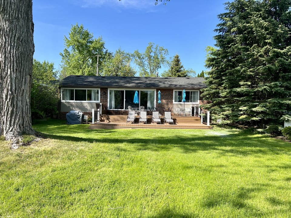 Two-level trex deck with three umbrella tables for 20.