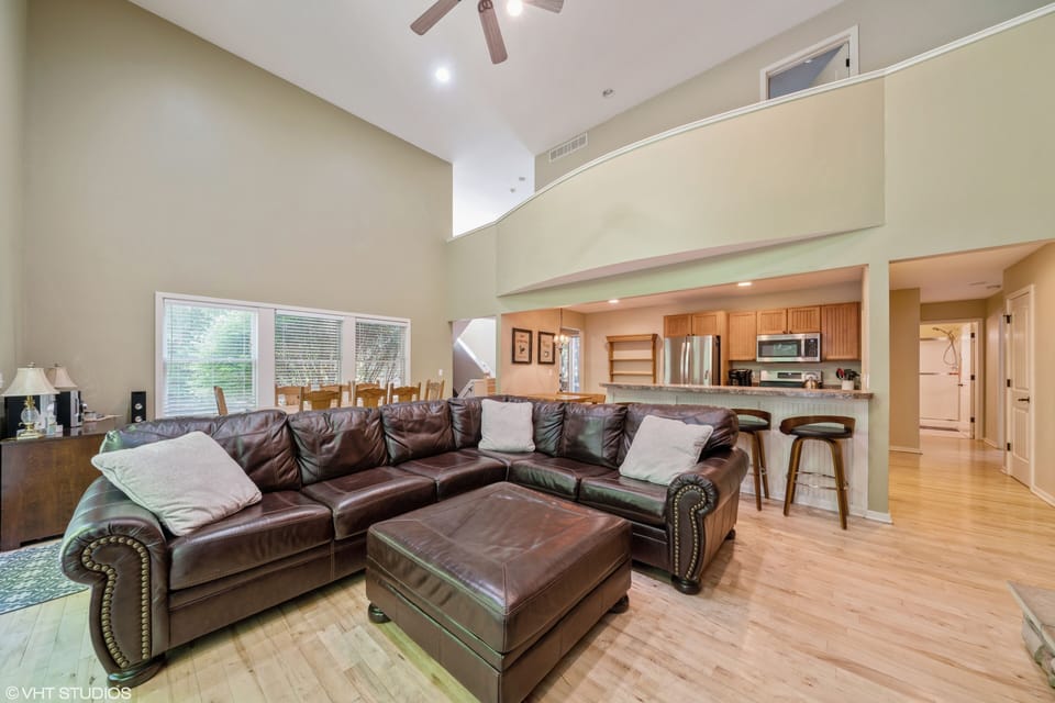 Great room w/ kitchen with bar seating dining areas.