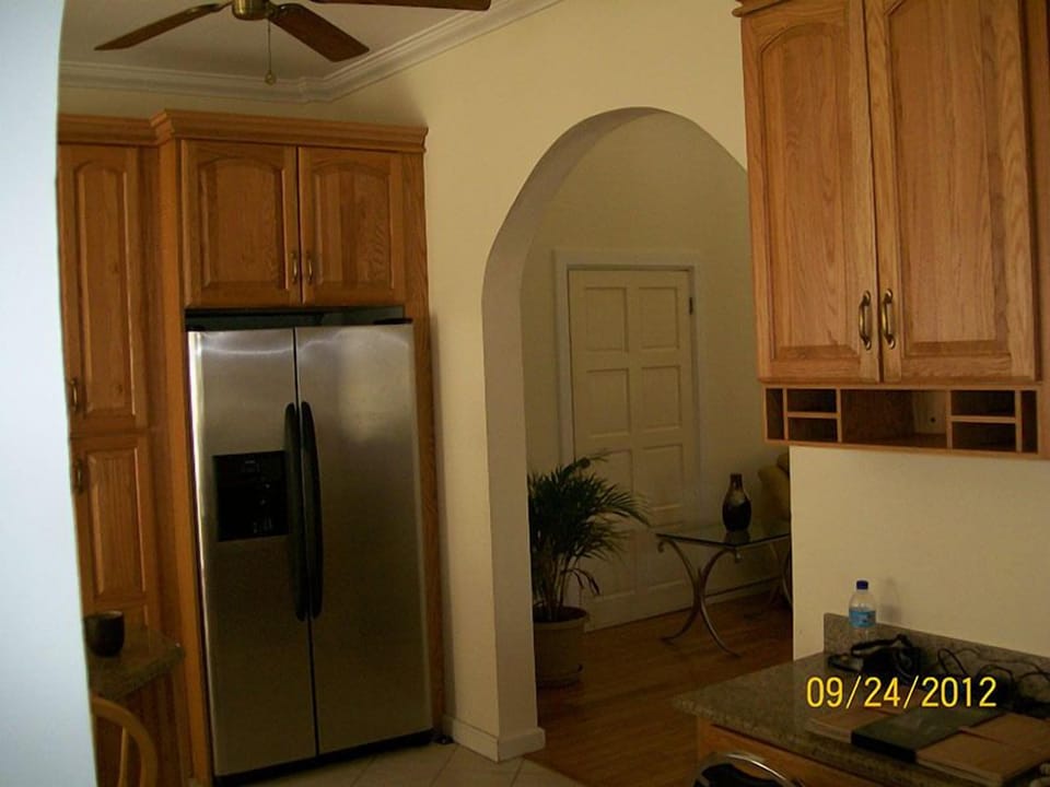 Partial view of kitchen showing stainless steel refrigerator with icemaker
