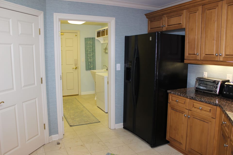 The kitchen leads to a laundry room and back door.