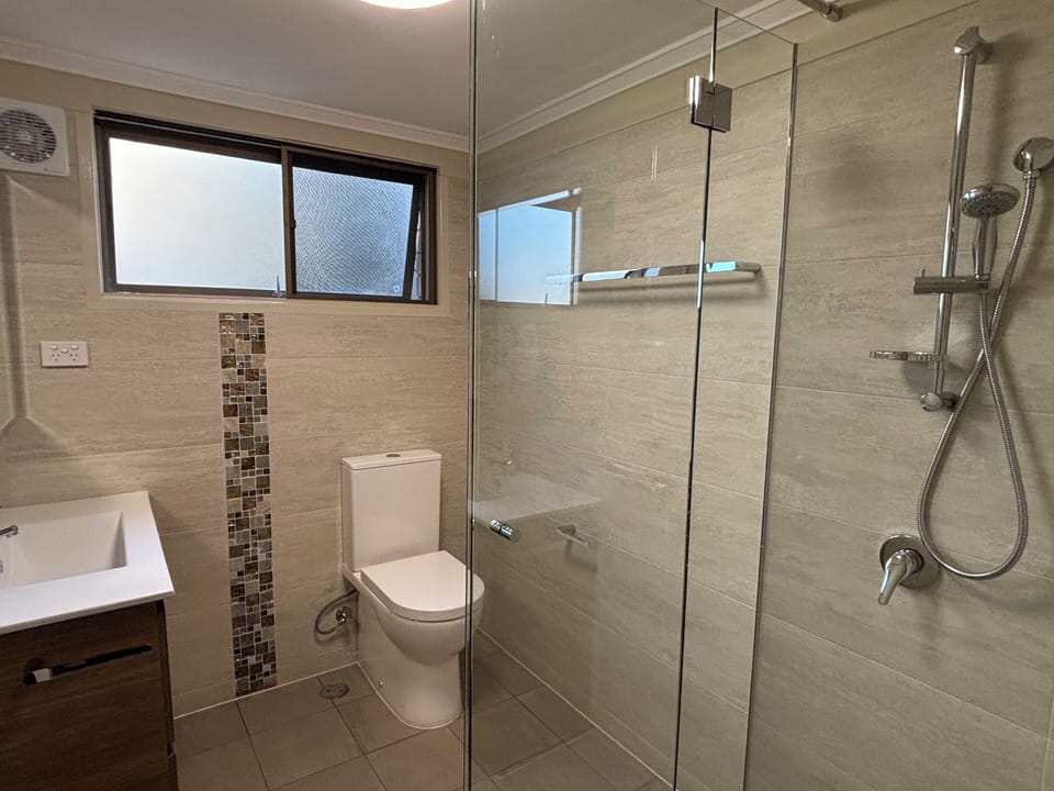 Downstairs bathroom with shower, vanity and toilet