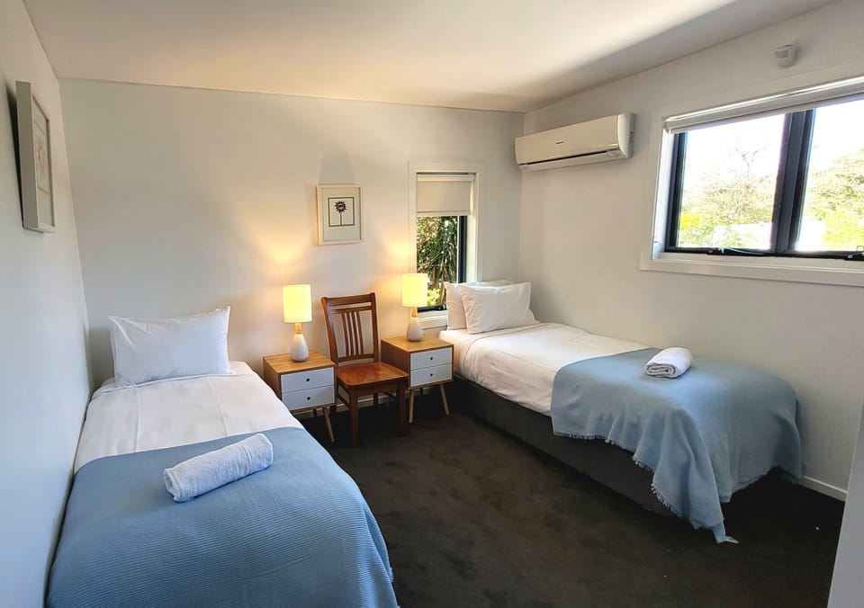 Upstairs bedroom with two single beds.