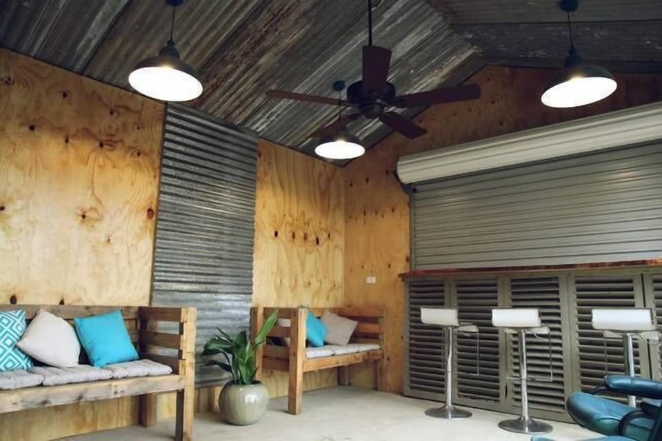 Outdoor sunroom with large flat screen TV and bar
