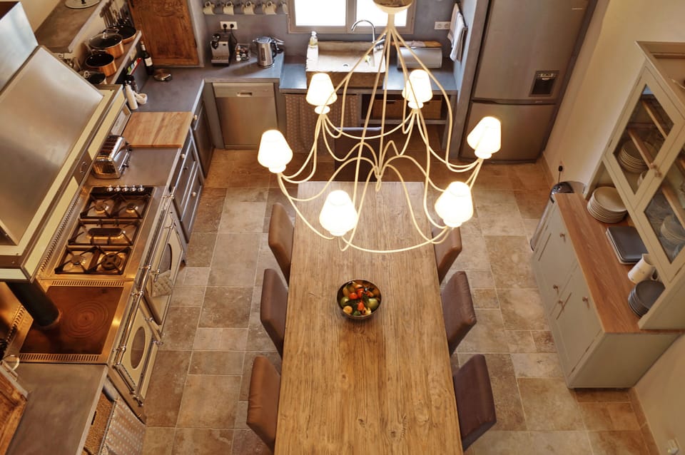 The kitchen table can seat 10 people for cooler days