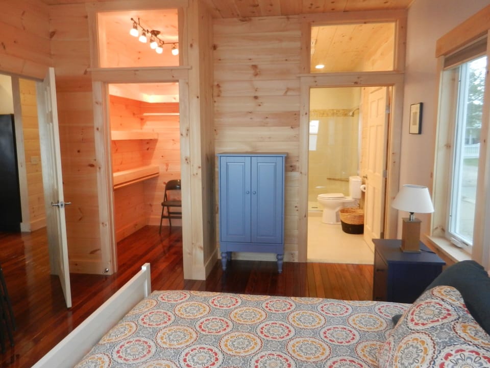 Master Bedroom, flat screen on wall at foot of bed next to door.