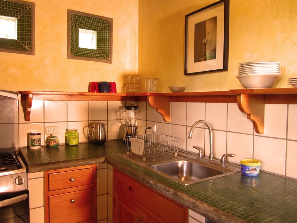 kitchen with stove and oven, frig, blender, and coffee maker