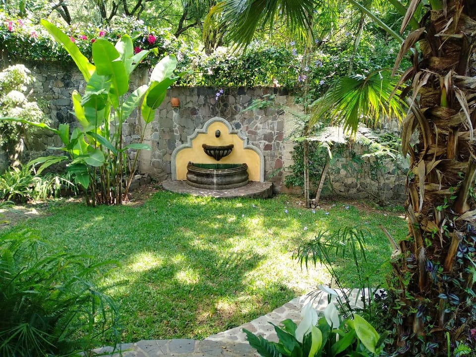 The apartment building located inside a secure, beautiful walled garden