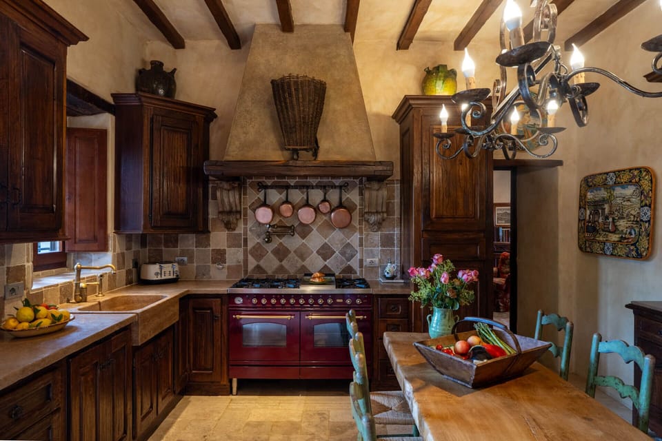 Modern kitchen with six-burner range, double ovens, full fridge and dishwasher.