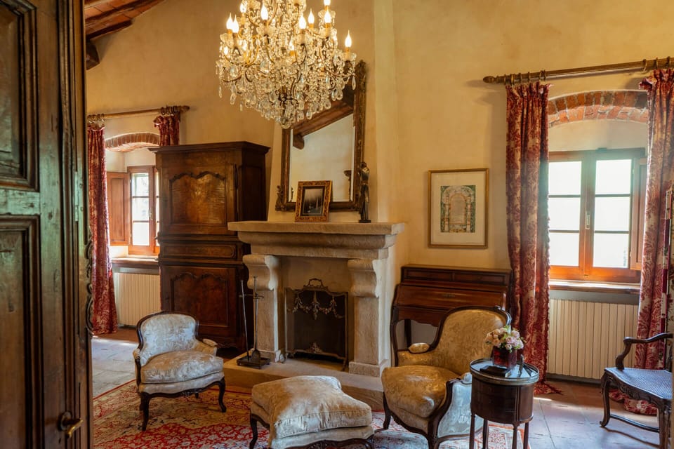 Antique chandeliers and a fireplace add charm and warmth.
