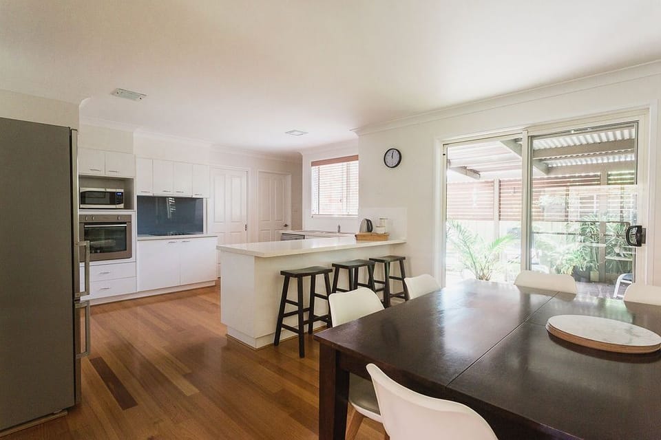 Spacious kitchen with partially stocked pantry. 