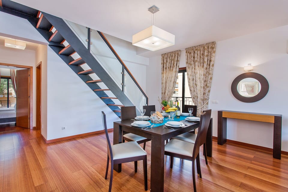 Dining area with stairs up to loft room