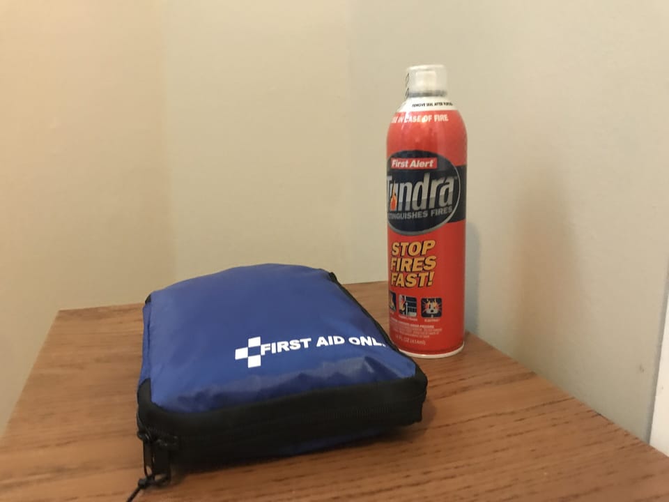 Fire extinguishers in two rooms, smoke detectors, and first aid kit readily avai