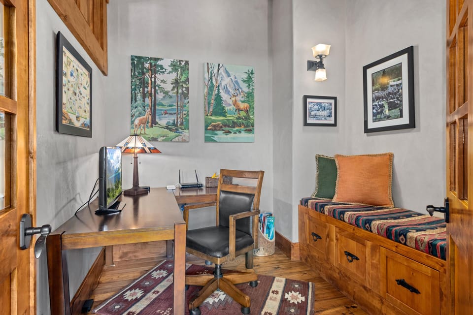 Cozy reading nook/Office  with vibrant art and warm wood accents