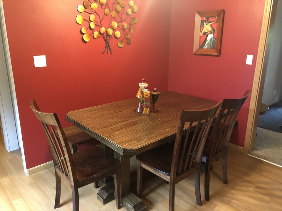 Kitchen table with bench seating on 2 sides and 4 chairs (3 pictured).